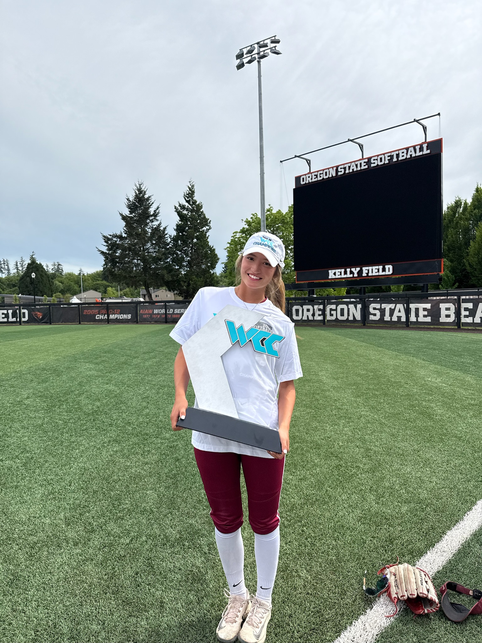 Alaina Valdez holding a championship trophy at Oregon State